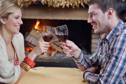 happy Young romantic couple and relaxing sofa in front of fireplace at winter season in home