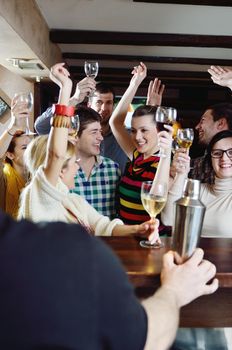 Group of happy young people drink wine  at party disco restaurant