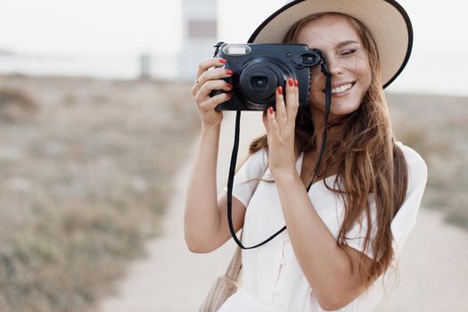 happy woman with camera outdoor. High quality photo