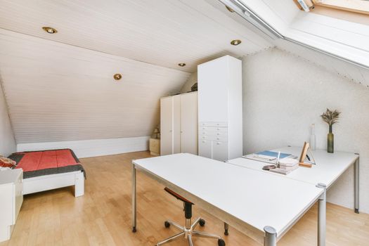 Cozy small attic room with a work area