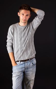 Handsome male portrait, isolated against black background