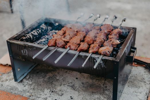 closeup of some meat skewers being grilled in a barbecue