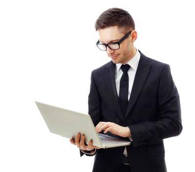 Businessman holding a laptop and smiling. Isolated against a white background.