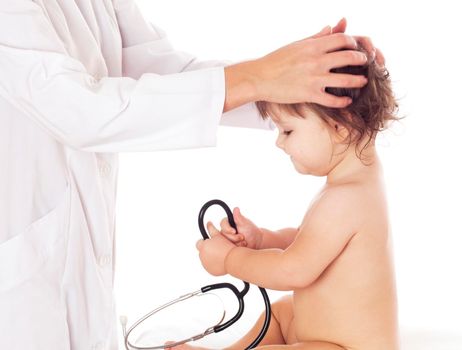 Doctor examines child's head with his hands, isolated on white.