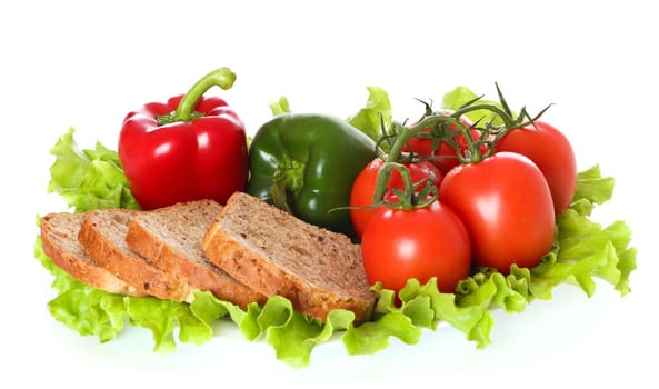 Fresh vegetables and bread on plate, isolated on white background.