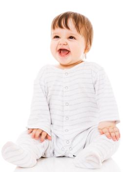 Cute baby sitting on the white floor background, wearing a sliders and smiling big. Isolated.