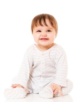 Cute baby sitting on the white floor background, wearing a sliders and smiling big. Isolated.