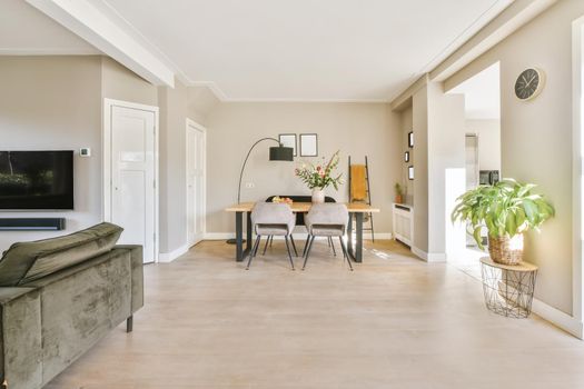 Elite dining room with velvet gray chairs and black lamp