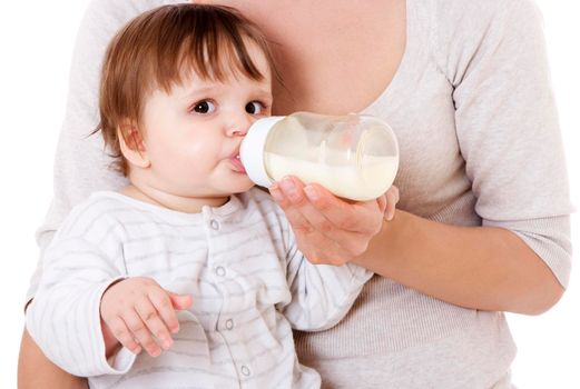 Mother feeding her newborn baby with the bottle. Isolsted on white.