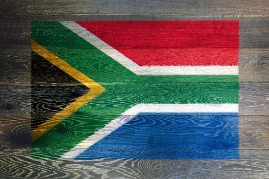 A South Africa flag on rustic old wood surface background