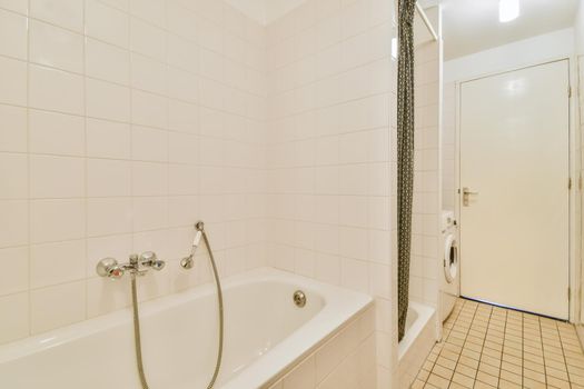 Interior design of bright cozy bathroom with bathtub
