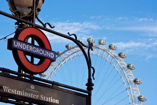 The Westminster sign and the London eye blue sky