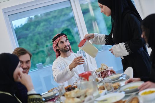 Muslim family having iftar together during Ramadan. Arabian people gathering for traditional dinner during fasting month.