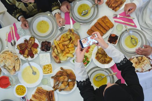 Top view of muslim family having Iftar during Ramadan holy month. Happy Arab muslim family breaking fast together.