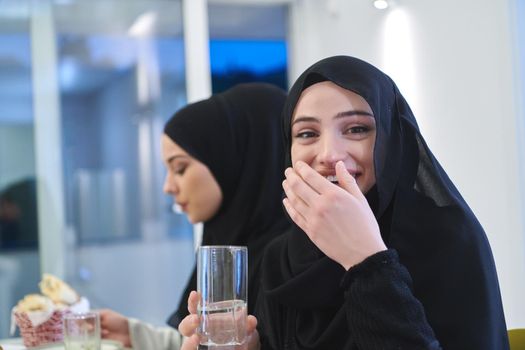 Muslim family having iftar together during Ramadan. Arabian people gathering for traditional dinner during fasting month.