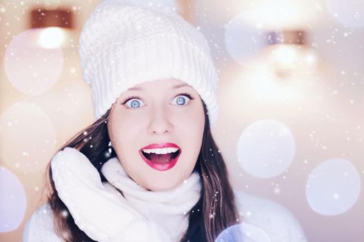 Christmas, people and winter holiday concept. Happy smiling woman wearing white knitted hat as closeup face xmas portrait, snow glitter and bokeh effect.