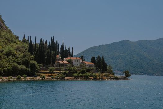 Blue boat in Bay of Kotor of Adriatic Sea, Montenegro. Beautiful view of the natural landscape. shore of Kotor. Scenic summer resort landscape. summer rest, vacation.