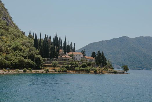 Blue boat in Bay of Kotor of Adriatic Sea, Montenegro. Beautiful view of the natural landscape. shore of Kotor. Scenic summer resort landscape. summer rest, vacation.