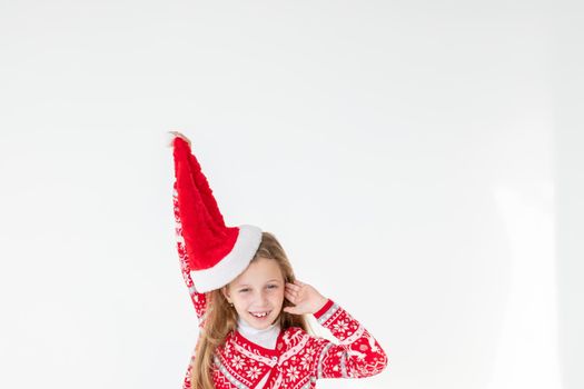 Photo portrait of kid dancing keeping hands up over head wearing red christmas sweater isolated on blue color background