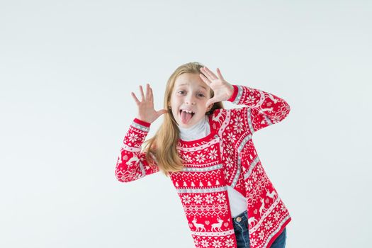 Photo portrait of kid dancing keeping hands up over head wearing red christmas sweater isolated on blue color background