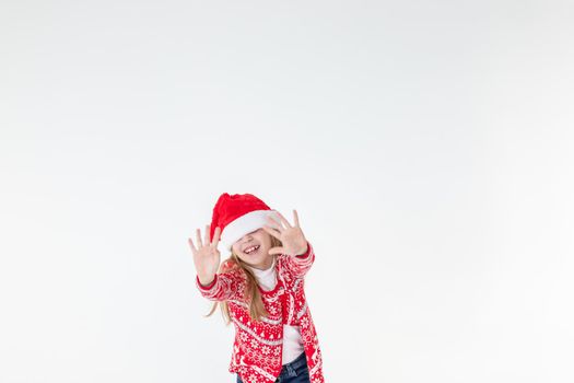 Photo portrait of kid dancing keeping hands up over head wearing red christmas sweater isolated on blue color background