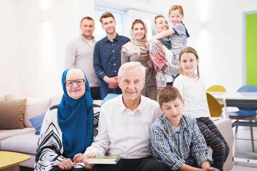 several generations portrait of happy modern muslim family before iftar dinner during ramadan feast at home