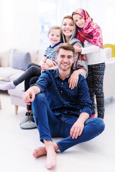 portrait of young happy modern muslim family before iftar dinner during ramadan feast at home