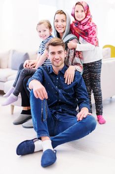 portrait of young happy modern muslim family before iftar dinner during ramadan feast at home