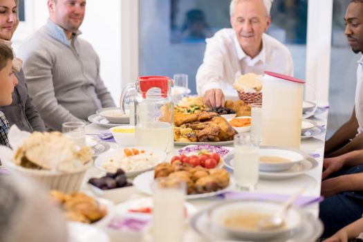 modern multiethnic muslim family enjoying eating iftar dinner together during a ramadan feast at home