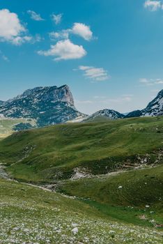 Mountain valley during sunrise. Natural summer landscape. Mountain peak green nature scenery. trail on green hill landscape