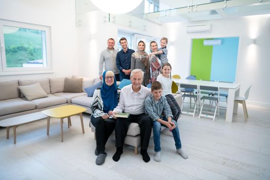 several generations portrait of happy modern muslim family before iftar dinner during ramadan feast at home