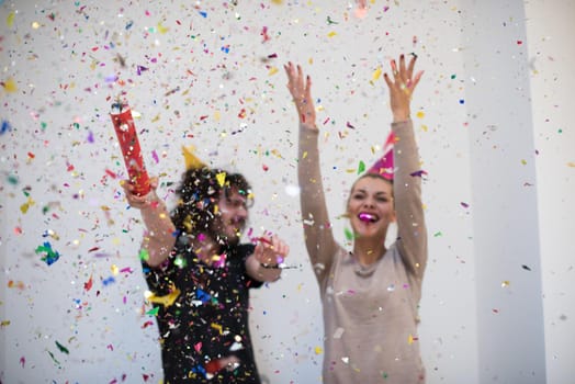 young romantic  couple in love  celebrating and blowing confetti decorations