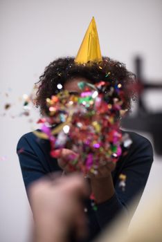 young man on party celebrating new year with falling confetti