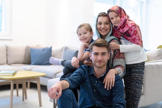 portrait of young happy modern muslim family before iftar dinner during ramadan feast at home
