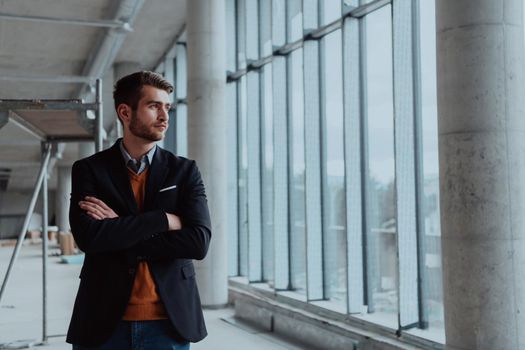 businessman entrepreneur in oversees the construction site of the startup office project