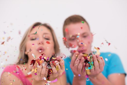 young romantic  couple in love  celebrating and blowing confetti decorations