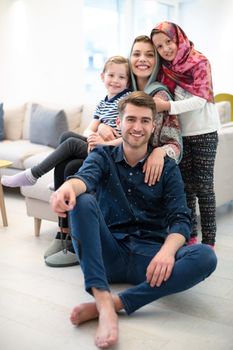 portrait of young happy modern muslim family before iftar dinner during ramadan feast at home