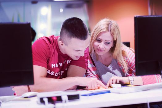 technology students group in computer lab school  classroom working on