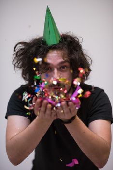 young man on party celebrating new year with falling confetti