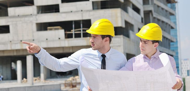 Team of architects people in group  on construciton site check documents and business workflow