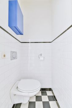 Small restroom with black and white checkerboard floor