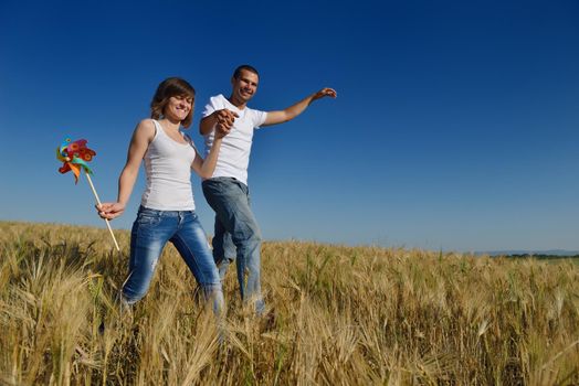 happy young couple in love have romance and fun at wheat field in summer