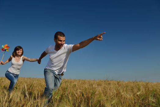 happy young couple in love have romance and fun at wheat field in summer