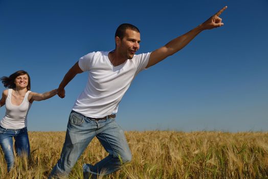 happy young couple in love have romance and fun at wheat field in summer