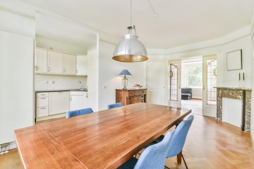 Comfortable dining room for four with an old wooden chest of drawers near the wall