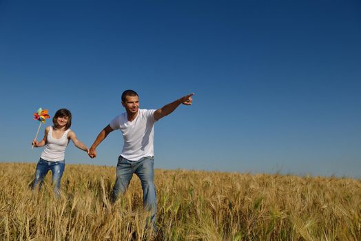 happy young couple in love have romance and fun at wheat field in summer