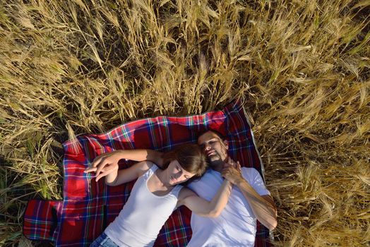 happy young couple in love have romance and fun at wheat field in summer