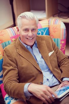 portrait of confident teacher sitting in colorful chair