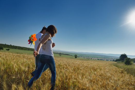 happy young couple in love have romance and fun at wheat field in summer