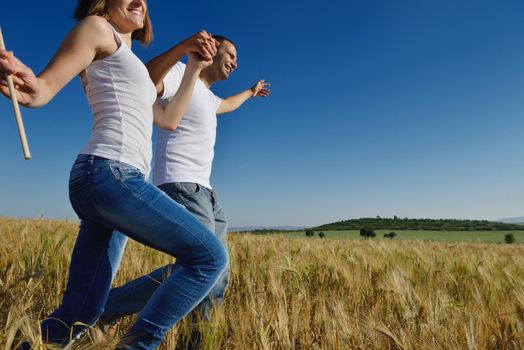 happy young couple in love have romance and fun at wheat field in summer